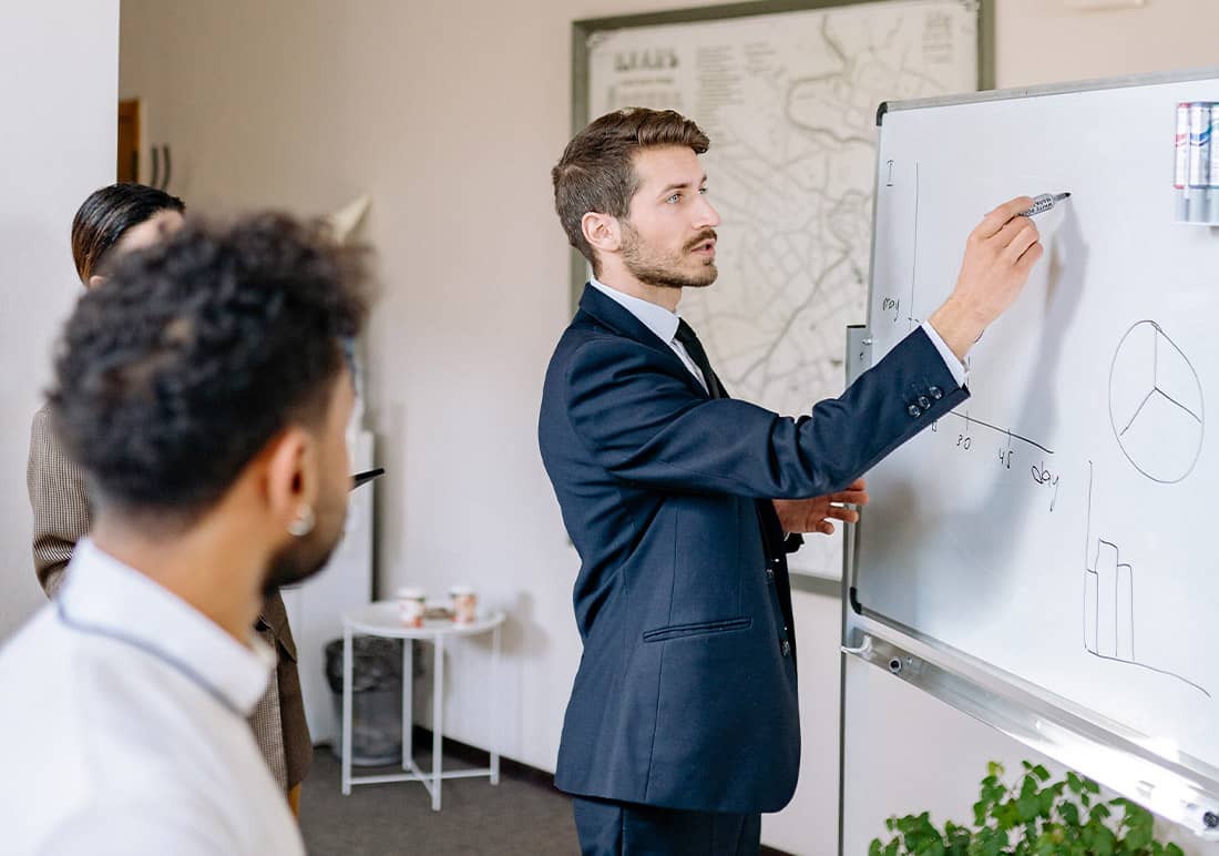 Man Drawing on Whiteboard White Rabbit 360 WR360 Creative digital agency offering brand identity, web development, 3D visualization, digital graphics, promotional videos, and printing services.